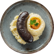 Boudin à l'oignon dans une assiette Gauci & fils